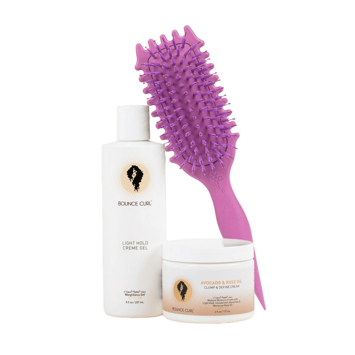 Hair care products including a bottle, a jar, and a purple brush on a green background