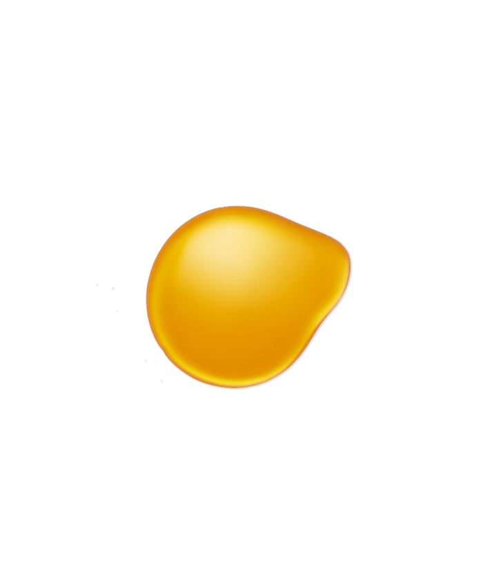 Close-up of a golden yellow oil droplet on a white background representing clean beauty and natural ingredients in Kakadu Body Oil.
