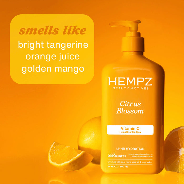 Hempz Citrus Blossom body moisturizer bottle with oranges on an orange background with scent notes
