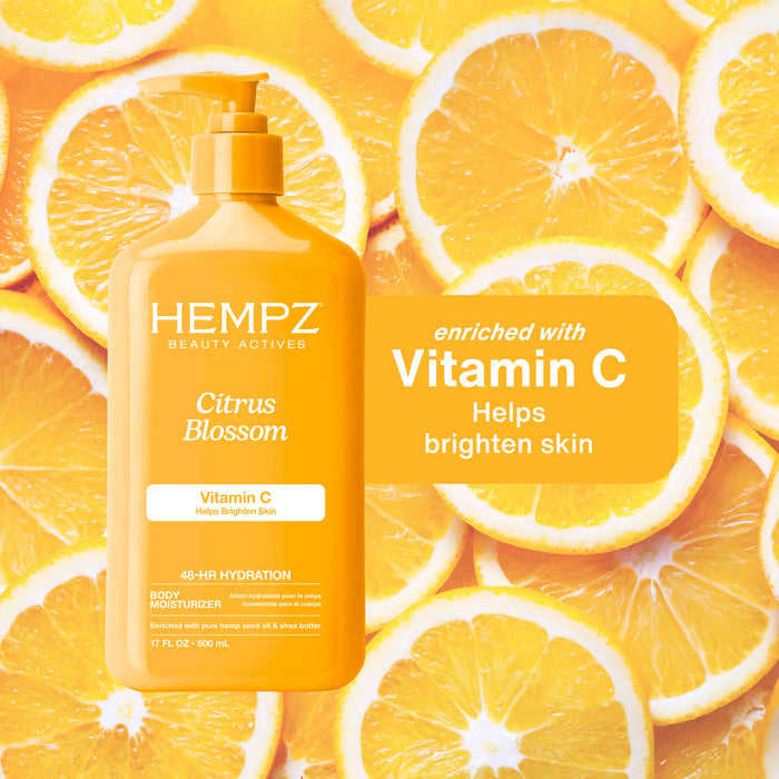 Hempz Citrus Blossom body lotion bottle with vitamin C benefits on an orange slice background