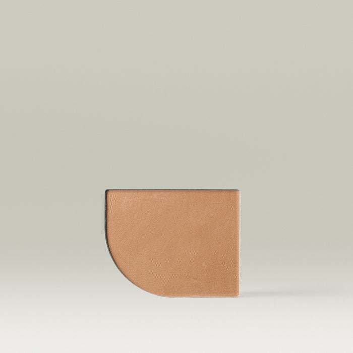 A single Tropic Jet Set bronzer refill pan in the shade Bali Bronze, featuring a large half-circle/half-rectangle shape with a warm tan powder surface, set against a soft neutral background.