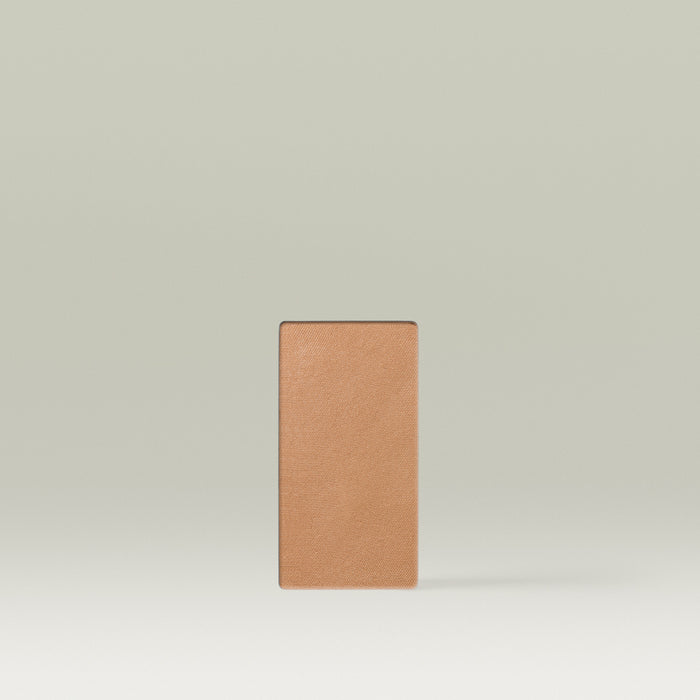 A Tropic Jet Set bronzer refill pan in the shade Bali Bronze, shown as a rectangular medium-sized pressed powder pan in a warm tan tone against a soft neutral background.
