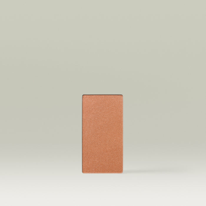 A Tropic Jet Set bronzer refill pan in the shade Havana Heat, shown as a warm deep-bronze rectangular pressed powder pan against a soft neutral background.