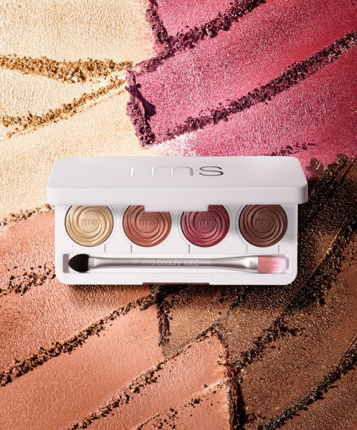 ReDimension Hydra Eyes Quartet eyeshadow palette featuring four shades in warm gold, bronze, rose, and deep brown with a dual-ended brush on a textured colorful background.