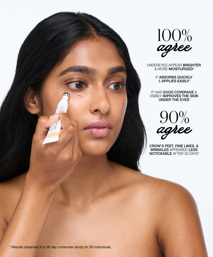 A woman applying ReFresh Eye Brightener Broad Spectrum SPF 30 + Correcting Tint under her eye using a roller applicator, showcasing claims of brighter, moisturized undereyes and reduced wrinkles.