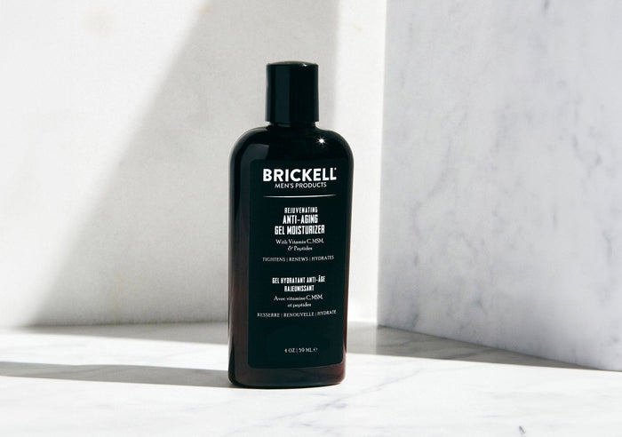Brickell Men's Products Rejuvenating Anti-Aging Gel Moisturizer with Vitamin C, MSM, and Peptides on marble background