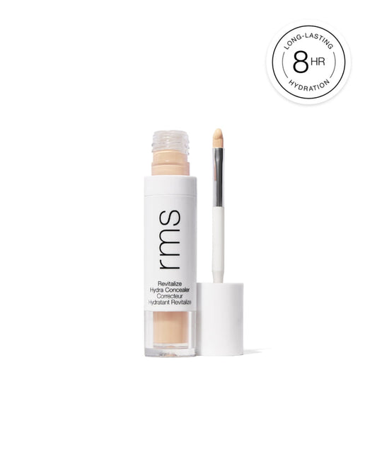 Open tube of Revitalize Hydra Concealer with applicator brush showing light beige creamy makeup, highlighting long-lasting hydration for 8 hours.