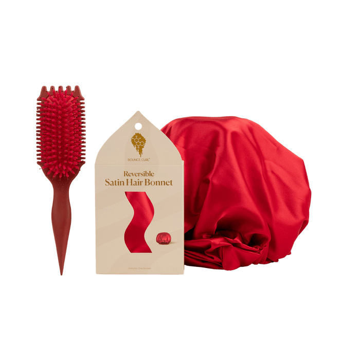 Red hairbrush, reversible satin hair bonnet, and packaging on a transparent background
