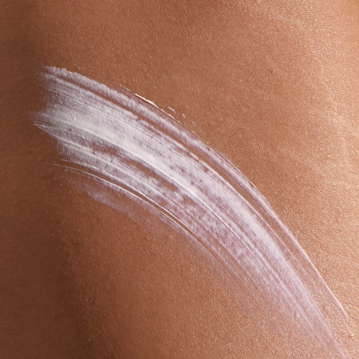 Model has applied Super Smooth onto their skin. Swiping it across.