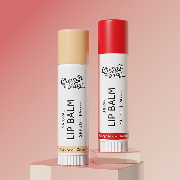 Two lip balms from 'Chemist at Play' on a pink background