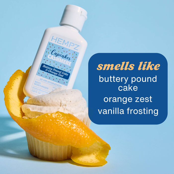 Hempz Travel-Size Cupcakes & Cashmere Moisturizing Body Lotion on a cupcake with orange slices against a blue background
